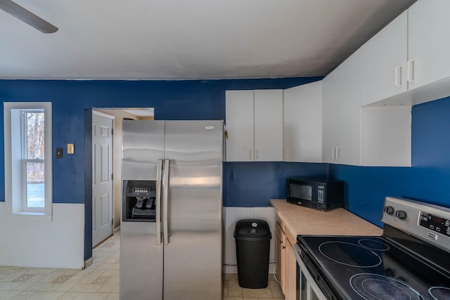 kitchen featuring white cabinets, ceiling fan, and stainless steel appliances