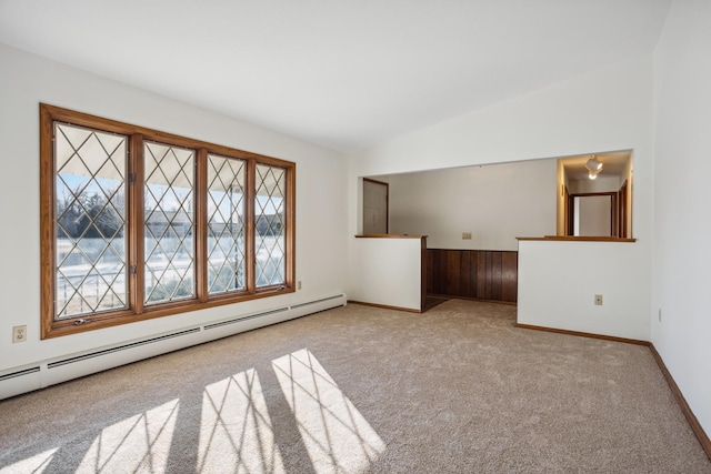 unfurnished room with light colored carpet, a baseboard radiator, and vaulted ceiling