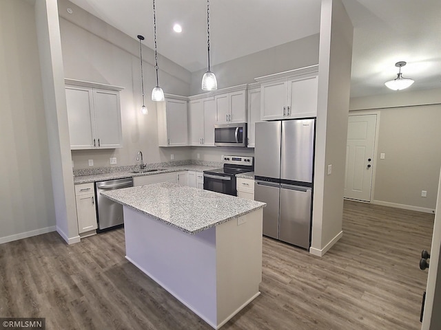kitchen featuring white cabinetry, sink, a kitchen island, and appliances with stainless steel finishes