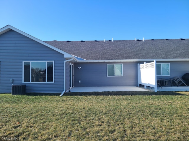 rear view of property featuring central air condition unit, a patio area, and a yard