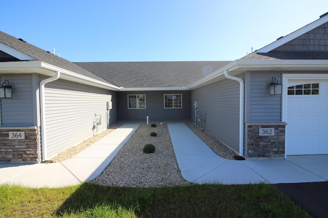 view of exterior entry with a garage