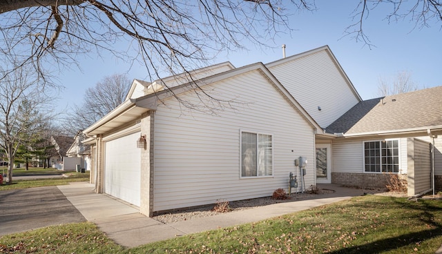 view of home's exterior featuring a yard and a garage