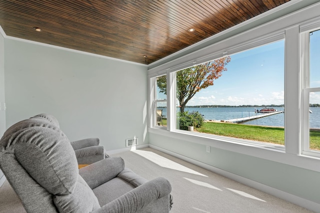 sitting room featuring carpet, crown molding, a water view, and wood ceiling