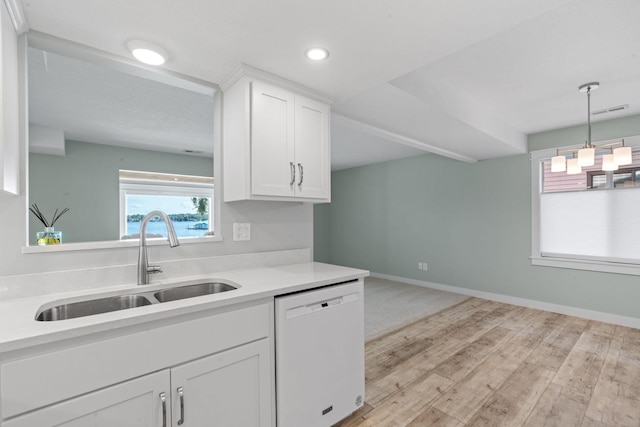 kitchen with white cabinets, sink, pendant lighting, light hardwood / wood-style flooring, and dishwasher