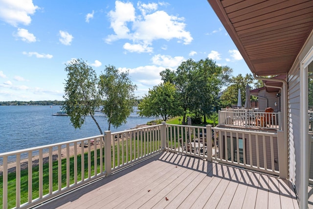 wooden terrace featuring a water view