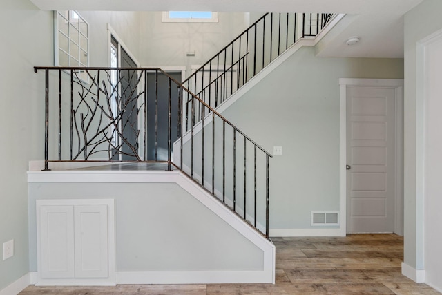 staircase with hardwood / wood-style floors