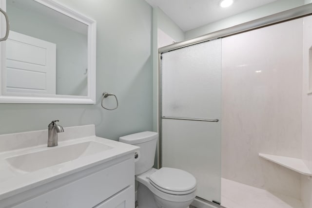 bathroom with vanity, toilet, and walk in shower