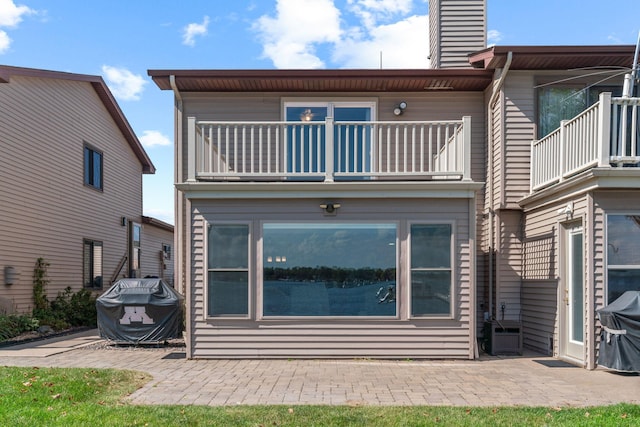 back of house with a patio area and a balcony