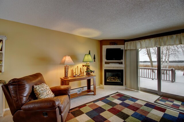 living room featuring light colored carpet, a textured ceiling, and a tiled fireplace