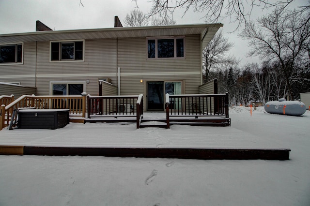 snow covered property featuring a deck