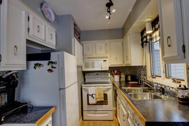 kitchen with tasteful backsplash, white appliances, sink, light hardwood / wood-style flooring, and white cabinetry