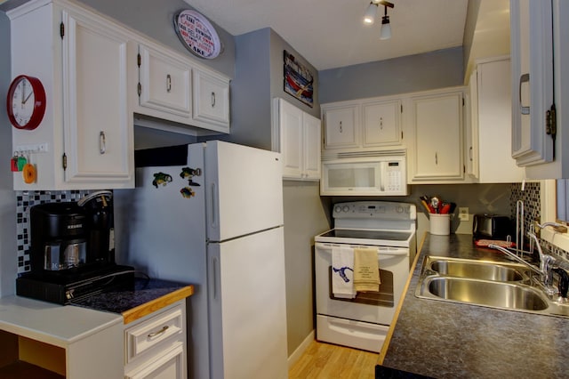 kitchen with white cabinets, light wood-type flooring, white appliances, and sink