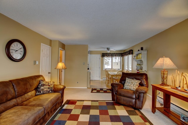 living room with carpet flooring, ceiling fan, and a textured ceiling