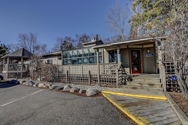 view of front of home featuring a sunroom