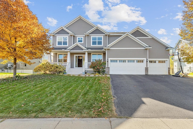 craftsman-style home featuring a garage and a front yard