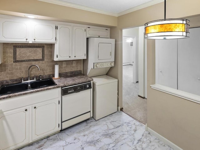 kitchen with white dishwasher, white cabinets, sink, decorative backsplash, and stacked washing maching and dryer