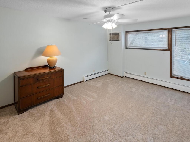 unfurnished room featuring ceiling fan, light colored carpet, and a baseboard heating unit