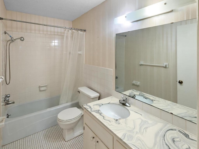 full bathroom with shower / bath combo, tile patterned floors, vanity, a textured ceiling, and toilet