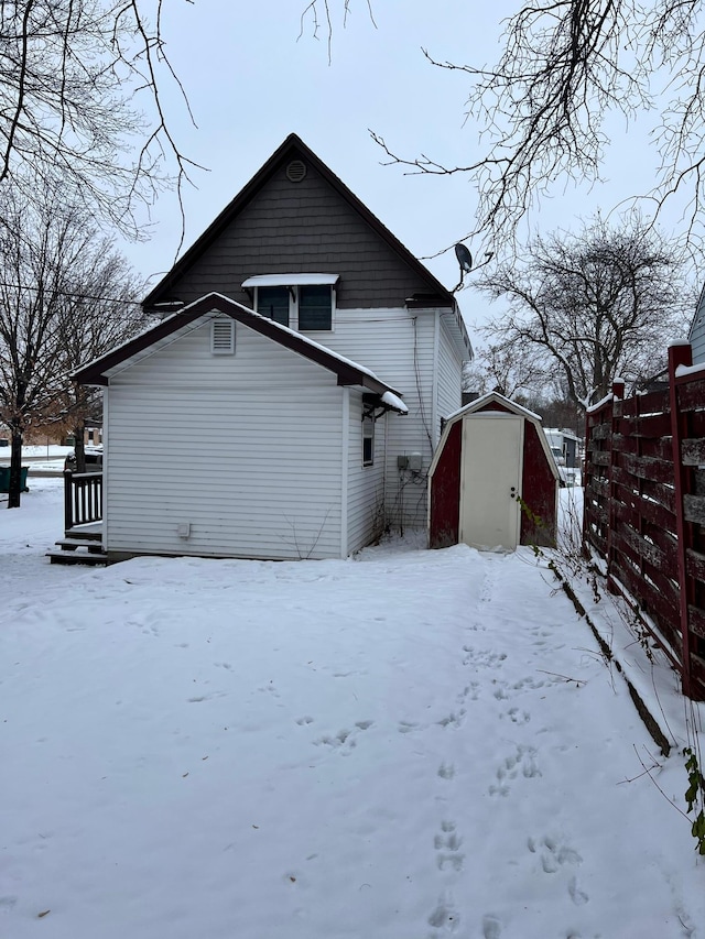 snow covered house with a shed