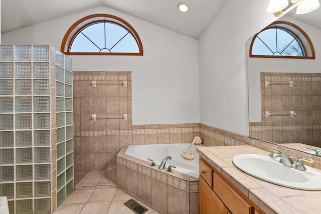 bathroom featuring vaulted ceiling, plenty of natural light, a garden tub, and visible vents