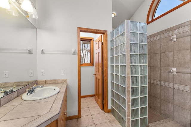 bathroom with vanity, tile patterned floors, and a tile shower