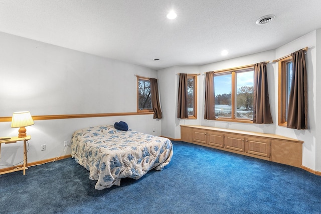 bedroom featuring visible vents, a textured ceiling, recessed lighting, carpet, and baseboards