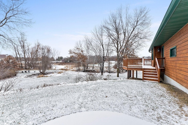 yard layered in snow featuring a deck