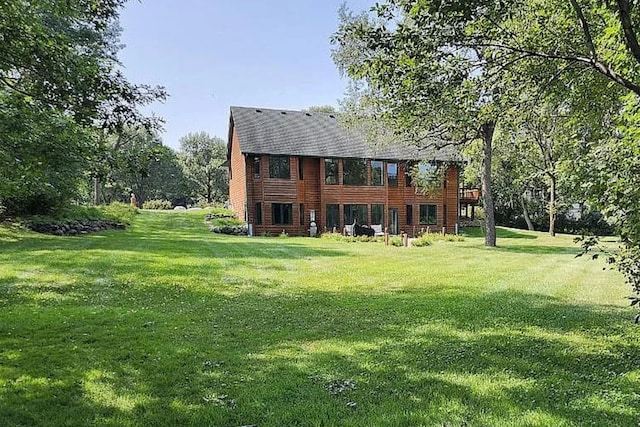 back of house with a lawn