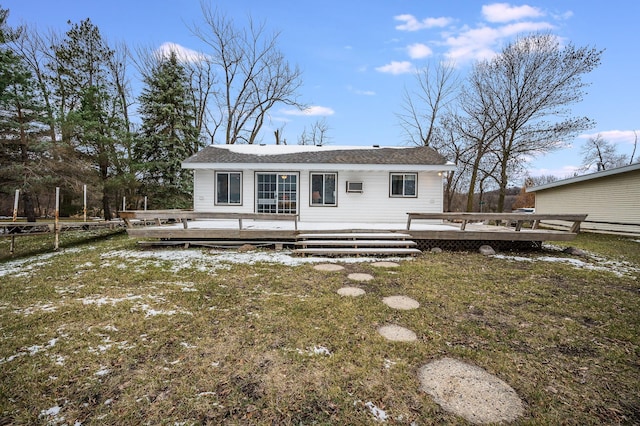 back of house with a lawn and a deck