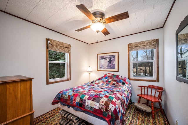 bedroom featuring ceiling fan and multiple windows