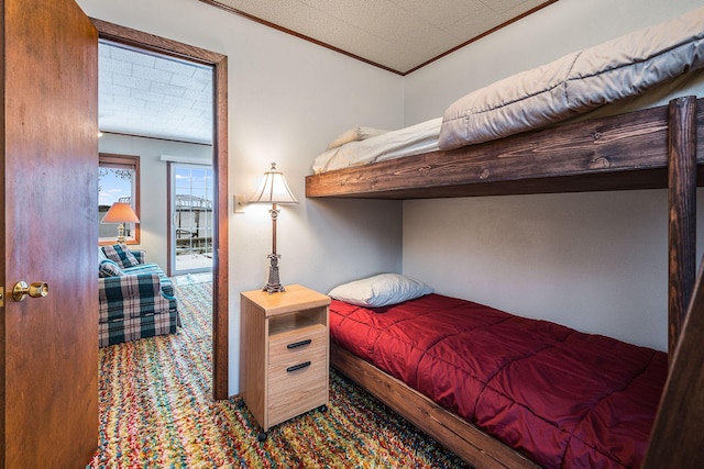 carpeted bedroom featuring crown molding