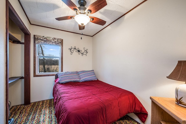 bedroom with ceiling fan, a textured ceiling, and ornamental molding