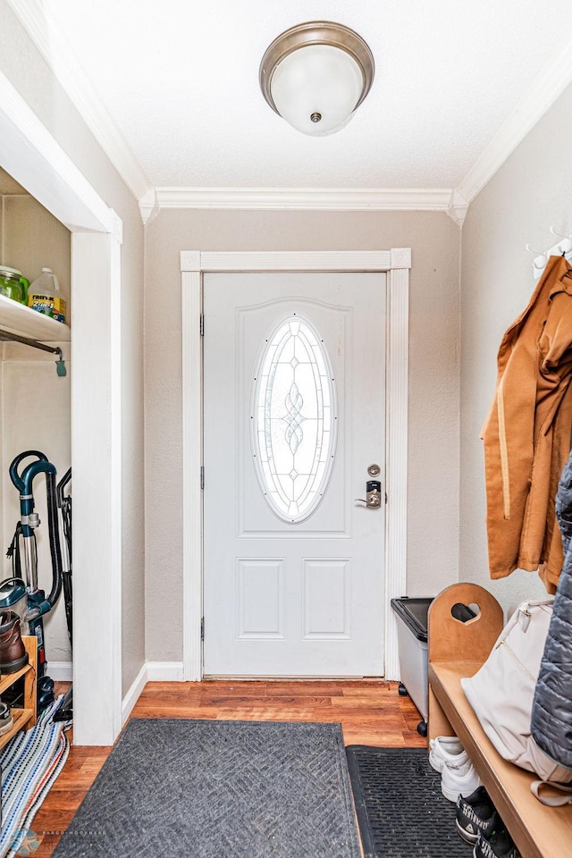 entryway with light hardwood / wood-style floors and ornamental molding