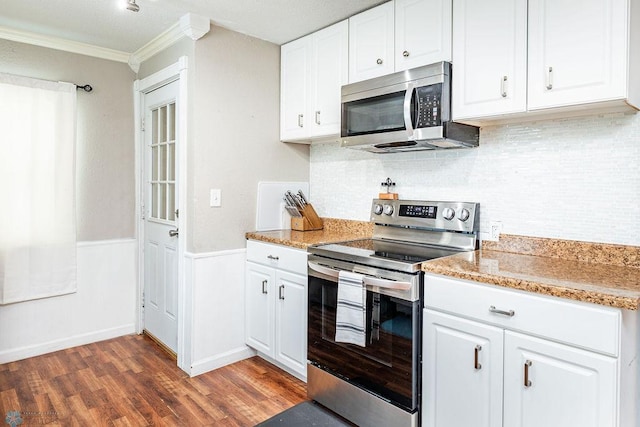 kitchen featuring crown molding, white cabinets, stainless steel appliances, and dark hardwood / wood-style floors