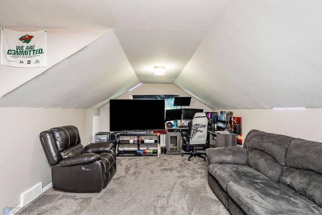 living room featuring carpet floors and vaulted ceiling