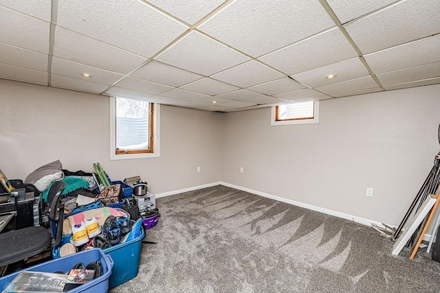 basement with carpet flooring and a drop ceiling