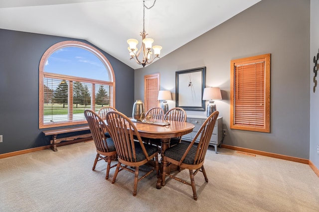 carpeted dining space featuring lofted ceiling and an inviting chandelier