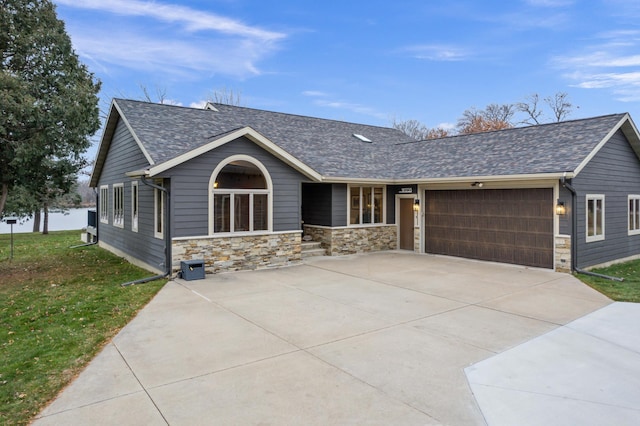 view of front of property with a garage and a front yard