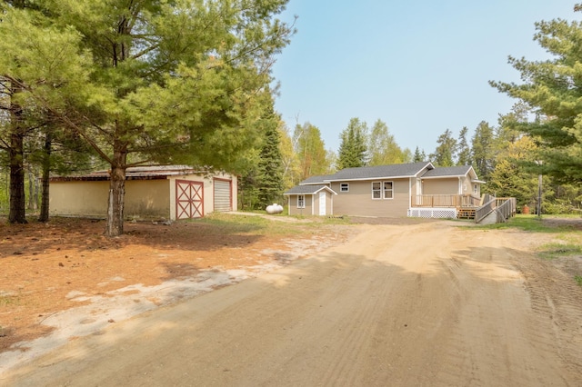 view of front of home with a deck and an outdoor structure