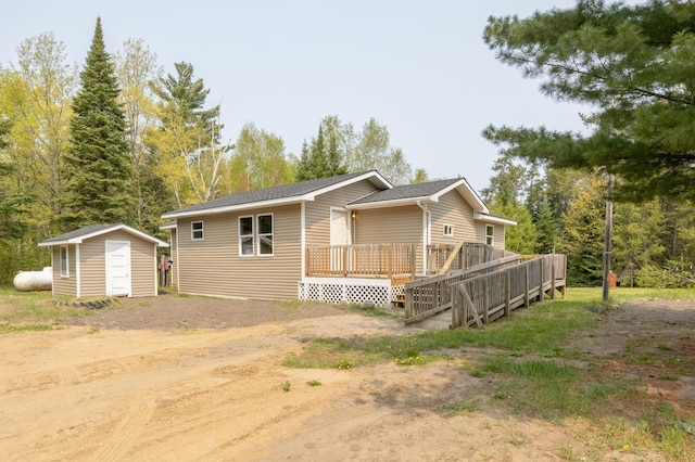 exterior space featuring a wooden deck and a shed