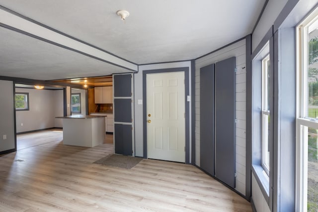 entrance foyer with a textured ceiling and light wood-type flooring