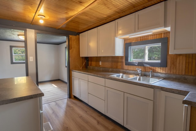 kitchen featuring white cabinetry, plenty of natural light, sink, and light wood-type flooring