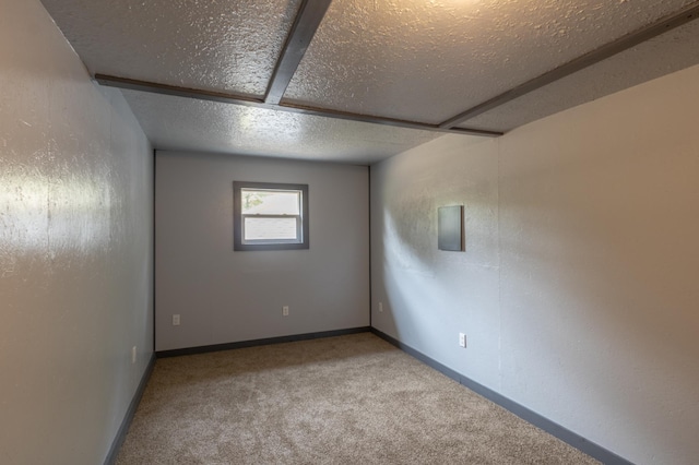 carpeted spare room with a textured ceiling