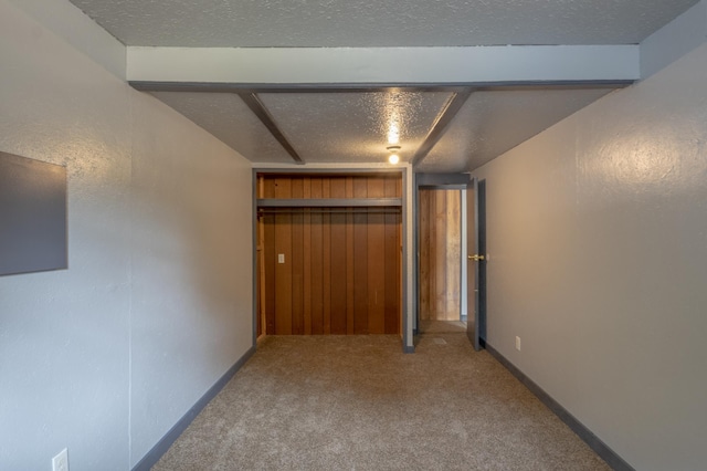 interior space with carpet floors and a textured ceiling