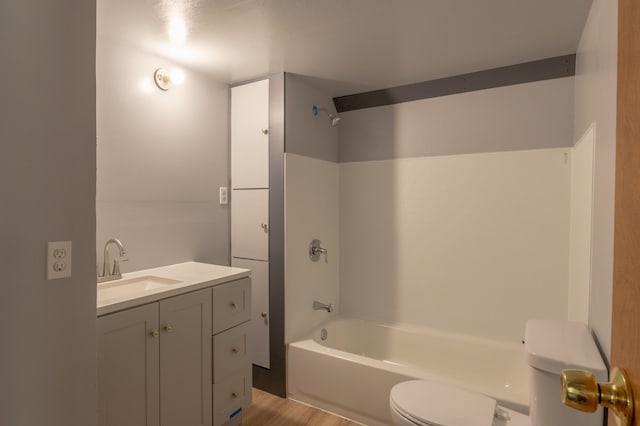 full bathroom with hardwood / wood-style flooring, vanity, toilet, and shower / washtub combination