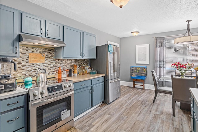 kitchen featuring pendant lighting, light hardwood / wood-style floors, high end appliances, and blue cabinets