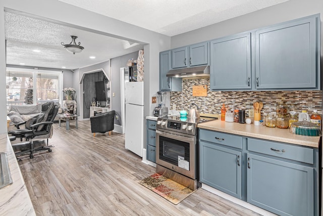 kitchen featuring white refrigerator, backsplash, light hardwood / wood-style floors, a textured ceiling, and stainless steel electric stove