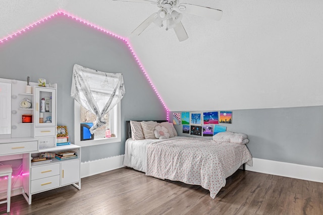 bedroom with dark hardwood / wood-style floors, vaulted ceiling, and ceiling fan