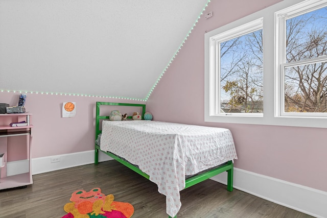 bedroom with dark wood-type flooring and vaulted ceiling