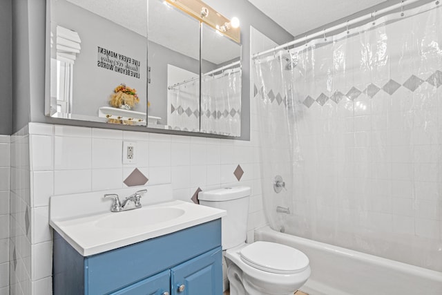 full bathroom with shower / bath combo, vanity, a textured ceiling, tile walls, and toilet